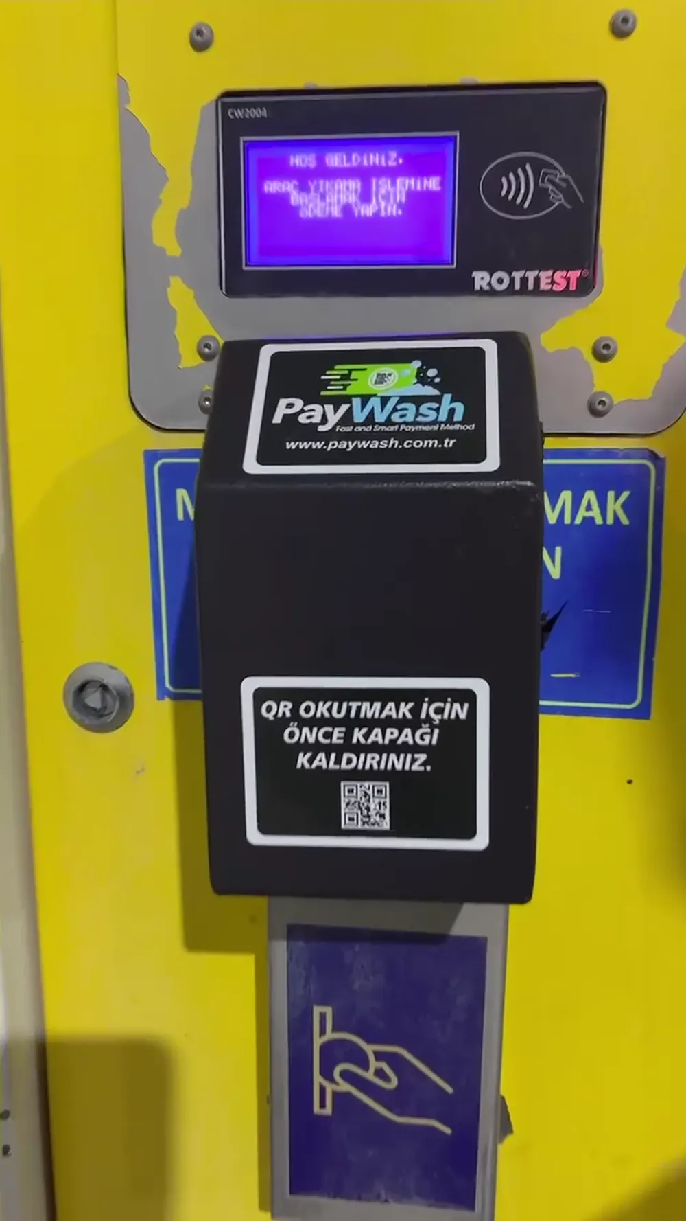 Jetonsuza dönüştürülmüş bir self servis yıkama ünitesinde PayWash barkod okuyucusu ve LED paneli